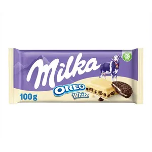 MILKA OREO BLANCO.Chocolate blanco con relleno sabor vainilla y trozos de galleta con cacao 100 g.